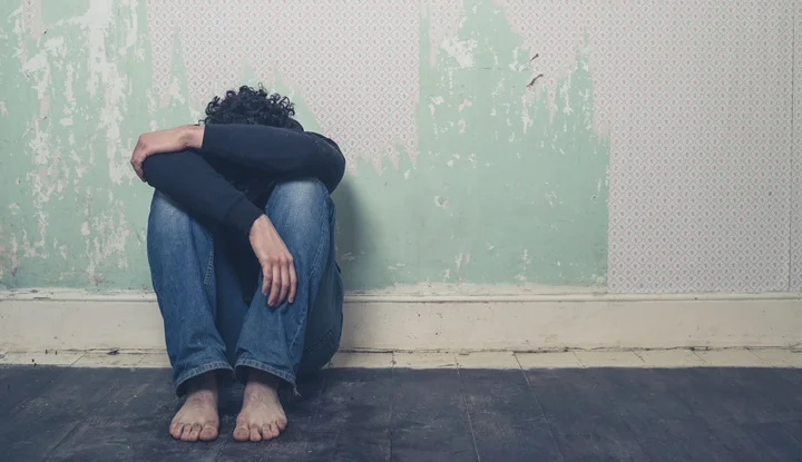 Sad young man in empty room
