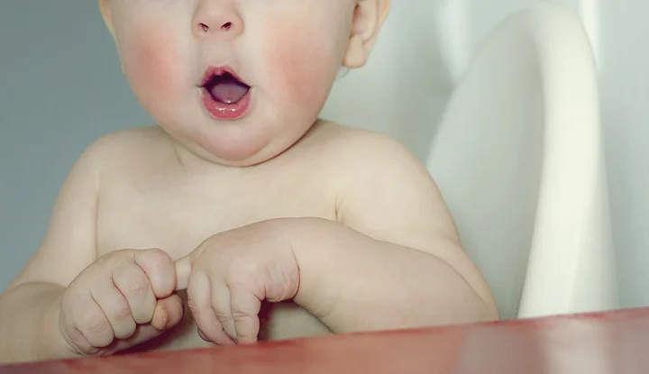 surprised kid sitting at table