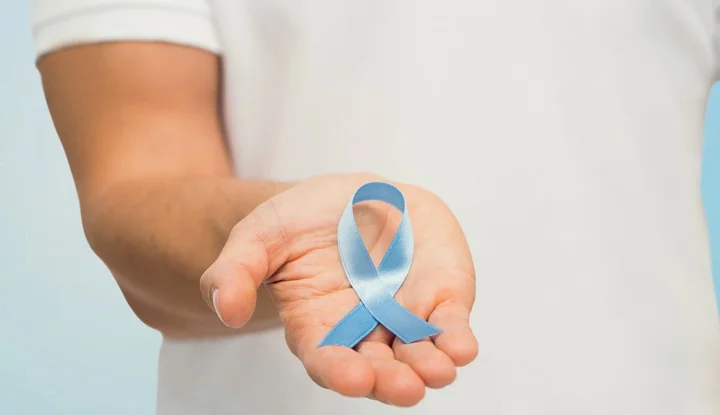 hand with blue prostate cancer awareness ribbon