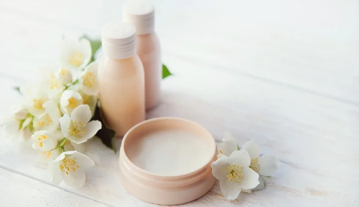 Spa setting with beauty cream and white  jasmine flower