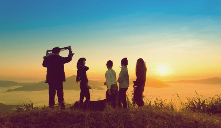 sunrise on misty  mountain with women and man