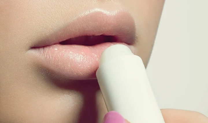 Female lips with a protective balm