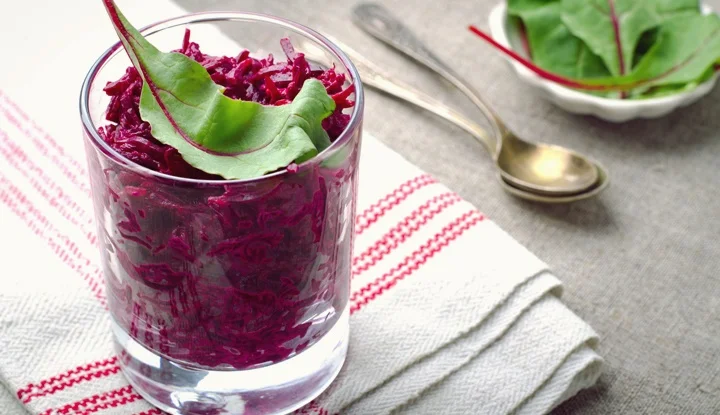Fresh beet salad with chard leaves in glasses on linen