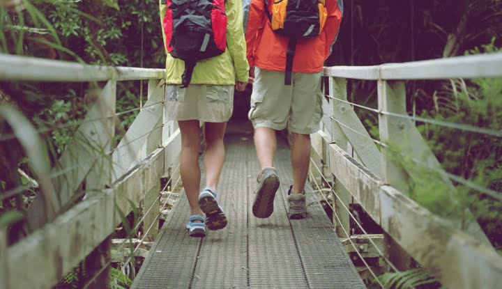 Young couple walking on bridge, rear view