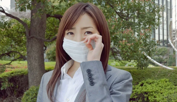 Young woman wiping eyes